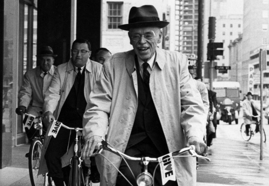 Paul Dudley White and several other men riding bicycles through the city